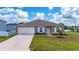 Charming single-story home featuring a well-manicured lawn and attached two-car garage at 761 Parrot Ct, Kissimmee, FL 34759