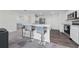 Modern kitchen featuring stainless steel appliances, breakfast bar, and neutral color palette at 761 Parrot Ct, Kissimmee, FL 34759