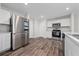 Bright kitchen features stainless steel appliances, wood-look floors and white cabinets at 761 Parrot Ct, Kissimmee, FL 34759
