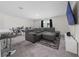 Open-concept living room features a comfortable sectional sofa, tv, and carpeted floors at 761 Parrot Ct, Kissimmee, FL 34759