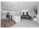 Open floor plan with stainless kitchen appliances and island, flowing into the living room at 761 Parrot Ct, Kissimmee, FL 34759