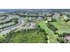 Expansive aerial view of a residential community adjacent to a golf course, lush greenery, and community amenities at 7834 Stoney Bay Loop, Kissimmee, FL 34747