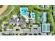Aerial view showcases a luxurious community pool, clubhouse, tennis courts, and bocce ball courts at 7834 Stoney Bay Loop, Kissimmee, FL 34747