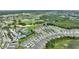 Serene aerial view of community featuring a golf course, pools, tennis courts, and well-maintained landscaping at 7834 Stoney Bay Loop, Kissimmee, FL 34747