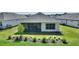 Well maintained backyard featuring a covered patio and a garden bed with ornamental grasses at 7834 Stoney Bay Loop, Kissimmee, FL 34747