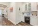 Stylish bar area with a wine cooler, custom cabinetry, and a countertop for serving at 7834 Stoney Bay Loop, Kissimmee, FL 34747