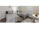 Charming bedroom featuring two twin beds with grey bedding and a neutral color palette at 7834 Stoney Bay Loop, Kissimmee, FL 34747