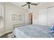 Cozy bedroom featuring ample natural light, a ceiling fan, and hardwood floors at 7834 Stoney Bay Loop, Kissimmee, FL 34747