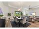 Open-concept dining area flowing into living space with scenic backyard views at 7834 Stoney Bay Loop, Kissimmee, FL 34747