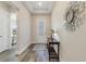 Bright entryway with wood floors, a decorative mirror, and a stylish console table at 7834 Stoney Bay Loop, Kissimmee, FL 34747