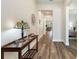 Inviting entryway showcasing wood floors, a decorative mirror, console table, and lots of natural light at 7834 Stoney Bay Loop, Kissimmee, FL 34747