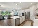 Open-concept kitchen with stainless steel appliances, a spacious island, and easy access to the living area at 7834 Stoney Bay Loop, Kissimmee, FL 34747