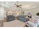 Cozy living room open to the kitchen, complete with comfortable seating and a ceiling fan at 7834 Stoney Bay Loop, Kissimmee, FL 34747