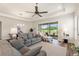 Comfortable living room with a large window and ceiling fan, with views of the outdoors at 7834 Stoney Bay Loop, Kissimmee, FL 34747