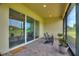 Covered patio featuring comfortable seating and scenic golf course views for relaxation at 7834 Stoney Bay Loop, Kissimmee, FL 34747