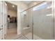 Modern shower with glass door, bench, and convenient shelving, plus access to walk-in closet at 7834 Stoney Bay Loop, Kissimmee, FL 34747