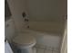Cozy bathroom featuring a bathtub and toilet, ideal for comfortable living at 7900 S Orange Blossom Trl # 2136, Orlando, FL 32809