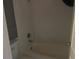 Bathroom with a white toilet, white shower/tub combination, and white walls at 7900 S Orange Blossom Trl # 2136, Orlando, FL 32809