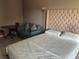 Bedroom featuring a queen bed, tiled floors, a comfortable sitting area, and small table with chairs at 7900 S Orange Blossom Trl # 2136, Orlando, FL 32809