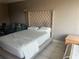 Bedroom featuring a queen bed, side table, tiled floors, and a comfortable sitting area at 7900 S Orange Blossom Trl # 2136, Orlando, FL 32809