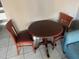 Dining area shows a round table with two chairs and tile flooring at 7900 S Orange Blossom Trl # 2136, Orlando, FL 32809