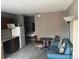 Cozy living area shows seating, dining table, tile flooring, and an efficient kitchenette at 7900 S Orange Blossom Trl # 2136, Orlando, FL 32809