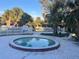 Leisure pool with a white fence and pool rules sign surrounded by large palm trees at 7900 S Orange Blossom Trl # 2136, Orlando, FL 32809