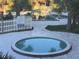 Leisure pool with a white fence and pool rules sign surrounded by large palm trees at 7900 S Orange Blossom Trl # 2136, Orlando, FL 32809
