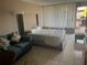 Well-lit studio apartment featuring a cozy bed, sofa, and convenient outdoor access at 7900 S Orange Blossom Trl # 2136, Orlando, FL 32809