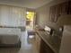 A studio apartment with a bed, kitchen, and balcony, perfect for urban living at 7900 S Orange Blossom Trl # 2136, Orlando, FL 32809