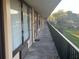 Exterior building walkway shows access to units with a metal railing and view of the grounds at 7900 S Orange Blossom Trl # 2136, Orlando, FL 32809