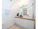 Bathroom with sleek, modern vanity, a large mirror, and bright lighting at 8112 Princess Palm Ln, Kissimmee, FL 34747