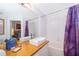 Bright bathroom with modern vanity, wooden countertop, bathtub, and purple curtains at 8112 Princess Palm Ln, Kissimmee, FL 34747