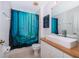Bright bathroom featuring a unique shower curtain and a modern countertop sink at 8112 Princess Palm Ln, Kissimmee, FL 34747