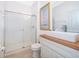 Bright bathroom features a shower with glass door and white vanity at 8112 Princess Palm Ln, Kissimmee, FL 34747