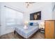 A bright bedroom with wood floors and a modern queen-size bed at 8112 Princess Palm Ln, Kissimmee, FL 34747