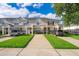 Attractive townhome featuring well-kept lawn and private parking at 8112 Princess Palm Ln, Kissimmee, FL 34747