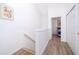 Bright hallway with white walls, wood floors, and access to bedrooms at 8112 Princess Palm Ln, Kissimmee, FL 34747