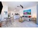 Open concept living room and kitchen featuring bar seating and tile floors at 8112 Princess Palm Ln, Kissimmee, FL 34747