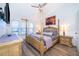 This main bedroom features a four-post bed, ceiling fan, and lots of natural light at 8112 Princess Palm Ln, Kissimmee, FL 34747