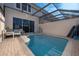 Enjoy this in ground pool with tile accents and a screened in lanai at 8112 Princess Palm Ln, Kissimmee, FL 34747