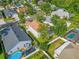 Aerial view of a fenced home backyard with a clear blue pool and playground equipment at 10957 Norcross Cir, Orlando, FL 32825