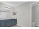 Bathroom featuring grey vanity with double sinks and updated fixtures at 10957 Norcross Cir, Orlando, FL 32825