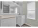 Bathroom featuring large vanity with single sink, decorative mirror, and natural light at 10957 Norcross Cir, Orlando, FL 32825
