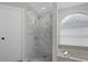 Elegant bathroom featuring a tiled walk-in shower and a soaking tub at 10957 Norcross Cir, Orlando, FL 32825