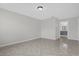 A clean and cozy bedroom features tiled floors, light-colored walls, and a view into the bathroom at 10957 Norcross Cir, Orlando, FL 32825