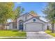 Charming two-story home with a well-manicured lawn and a two car garage at 10957 Norcross Cir, Orlando, FL 32825