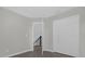 Hallway features an open doorway, staircase access and a double door closet at 10957 Norcross Cir, Orlando, FL 32825