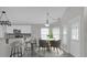 Modern kitchen features granite counters, stainless microwave, island bar seating and dining area at 10957 Norcross Cir, Orlando, FL 32825