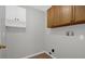 Bright laundry room features sleek cabinetry and convenient washer/dryer hookups at 10957 Norcross Cir, Orlando, FL 32825